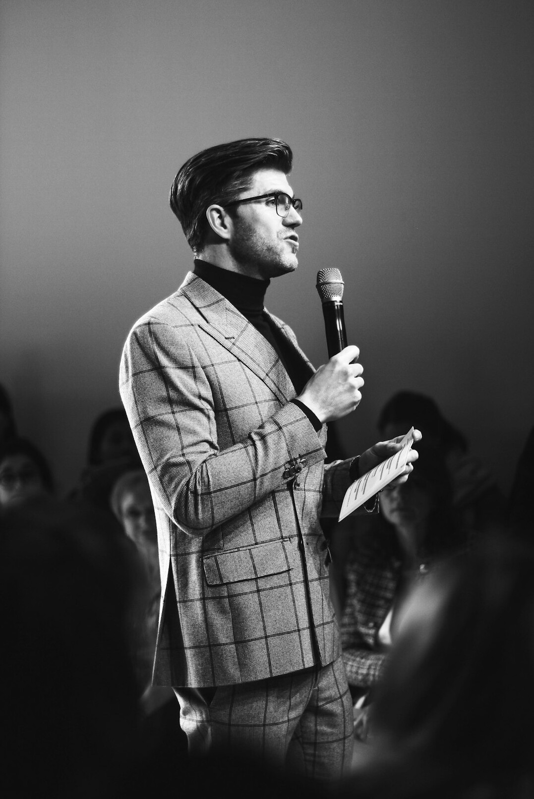 person speaking on stage confidently